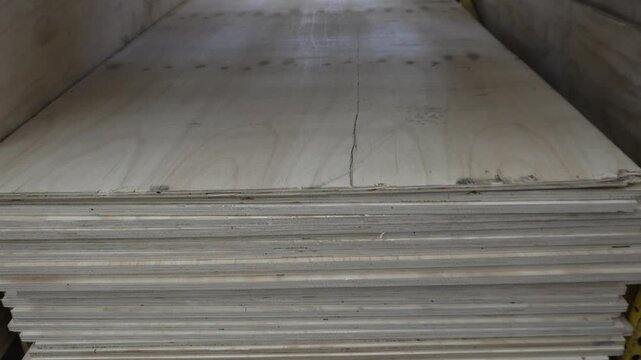 Large storage of various wood panels and timber sheets in a warehouse