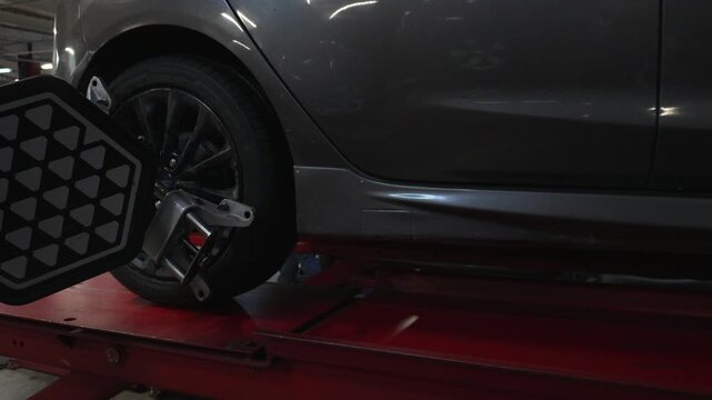 Car wheel with alignment sensor equipment in a mechanical workshop