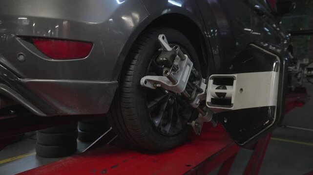 Car wheel with alignment sensor equipment in a mechanical workshop