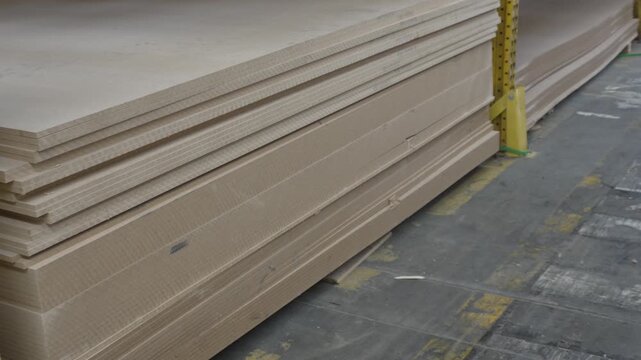 Large storage of various wood panels and timber sheets in a warehouse