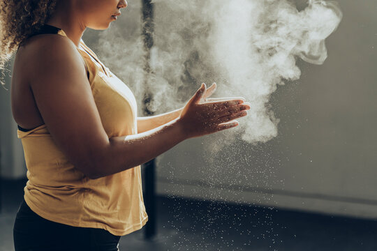 Athletic woman preparing for workout in gym