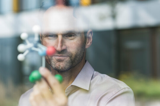 Portrait of scientist with atomic model