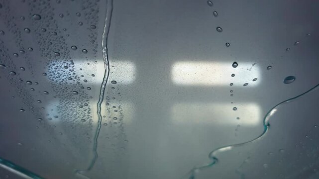 A view from inside a vehicle during an automatic car wash at a service center.