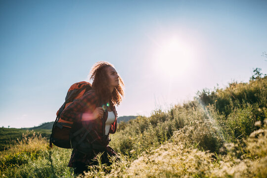Teenage girl with backpack in nature