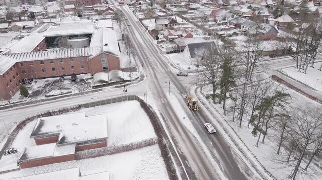 Snow Removal Truck Clearing Icy Urban Roads In Herning Winter Traffic For Public Safety And City Infrastructure Maintenance.