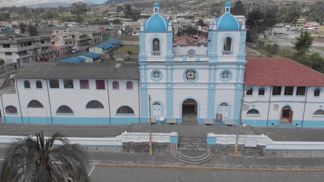 Main Church of Aloasi City near Ambato with a colonial architecture on a bright day aerial view.