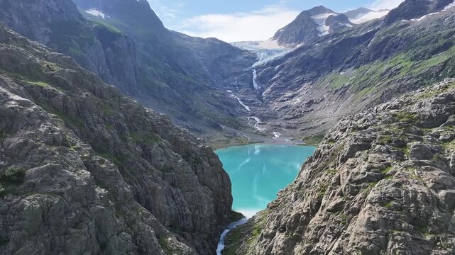 aerial view of trift bridge and glacial lake in swiss alps 