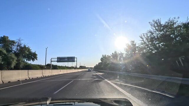 Driving on D1 highway in western Slovakia with low sun glare and clear blue sky