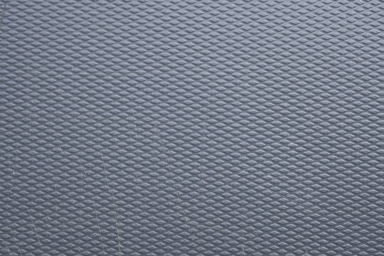 Grey diamond plate texture background with scratched rubber surface