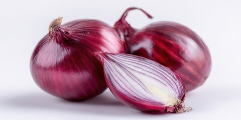 The Red Onion Trio with One Halved Showing Layers on White Background