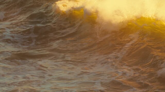 Slow motion video: Ocean Waves at high tide roll in and crash against the coastal cliffs, huge rocks.  Big Sea waves crashing against the coastline rocks. Crashing waves creating huge splashes.