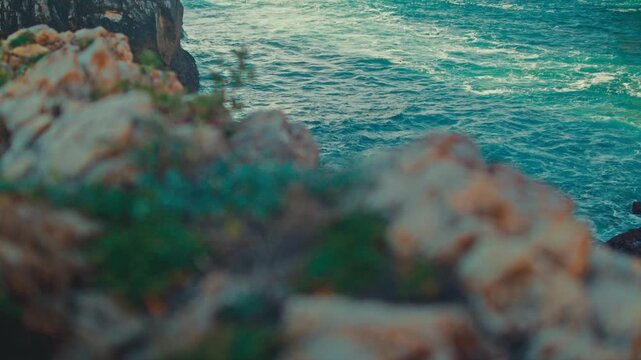 Beautiful nature seascape with azure water and high cliffs on a sunny summer day. Beautiful scenery. Stunning oceanscape featuring azure waters and rocks, blue sky and rolling waves to the shore.