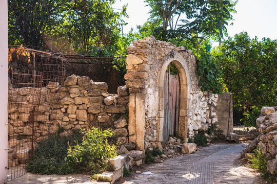 a narrow street in the small Greek town of Margarites on the island of Crete