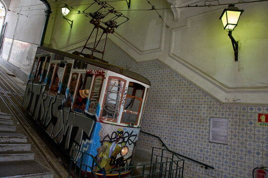 Side view of the Ascensor da Gloria funicular carriage with street art parked on the steep incline in Lisbon, Lisboa, Portugal, Europe.