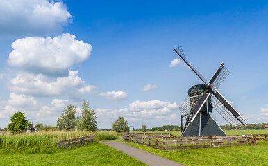 Fototapeta premium Historic Terpensmole windmill at the bicyle path near IJlst, Netherlands