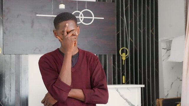 Black painting behind black curator analyzing young man in maroon sweater, arms crossed, modern gallery interior, geometric canvas and lamp in background, thoughtful gaze, quiet mood, soft daylight,