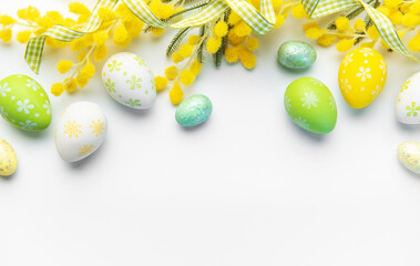 Easter eggs with mimosa flowers and ribbon border
