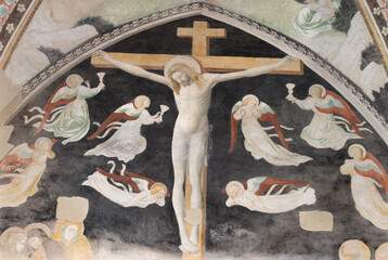 Naklejka premium NOVARA, ITALY - JANUARY 16, 2026: The fresco of Crucifixion among the angels in the church Chiesa di San Nazaro by unknown artis from 15. cent.