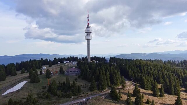 Tower Snezhana on peak of Snezhana covered with spruce forests in Rhodope mountains