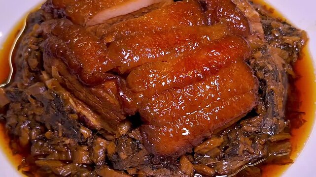 A traditional Chinese dish, this flavorful fusion features pork belly cooked in soy sauce with salted vegetables and shiitake mushrooms, creating a deliciously salty and savory experience.