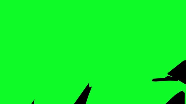 Black shards and broken pieces falling away to reveal a solid bright green chroma key background for creative transition video effects