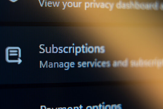Close-up of Subscriptions menu on a digital screen with Manage services and subscriptions text, concept for online account management and recurring billing services