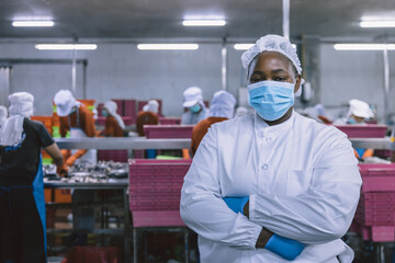 Portrait of African black woman worker in food factory standing confident at with hygiene uniform