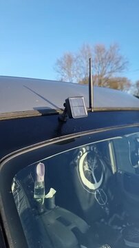 Vertical: Solar powered meshcore off-grid communication beacon on camper van roof recharging in sun