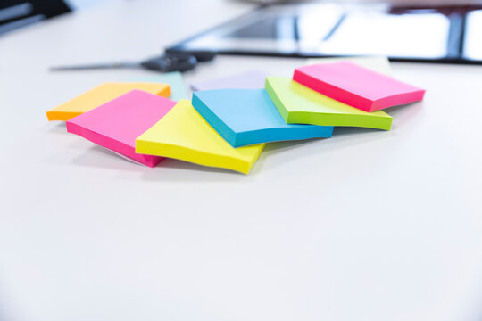 Colorful sticky notes on office desk for planning and organization