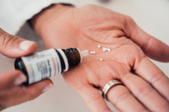 Doctor dispensing homeopathic remedy for alternative treatment