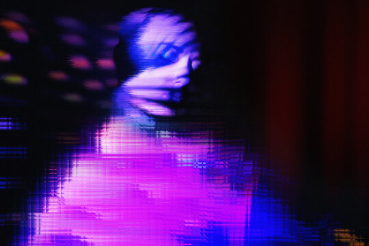 Woman in neon pink virtual reality with glitch effect and hologram