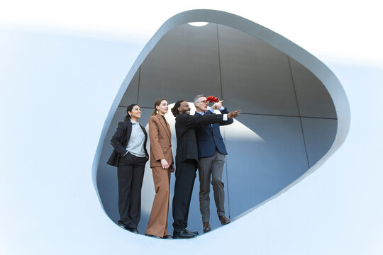 Business team looking to the future with binoculars outdoors in Barcelona