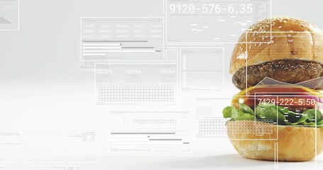 Displaying sesame bun burger sitting on right of studio set, with clear UI readouts, copy space