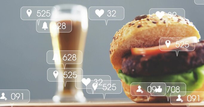 Showing sesame burger on wooden counter with blurred glass and floating social icons, copy space