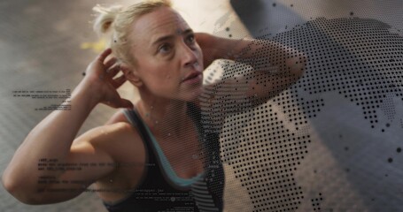 Performing adult woman doing core exercise on pavement wearing dark tank with halftone map and code