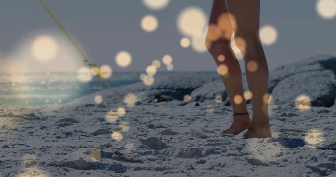 Women shifting weight stepping sandy shore bokeh drifting across legs rope leading buoy for travel