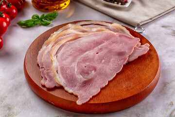 Sliced pork ham over board