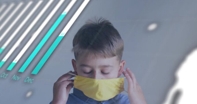 Male child lifting yellow mask protecting health after alert, bar chart shifting over face