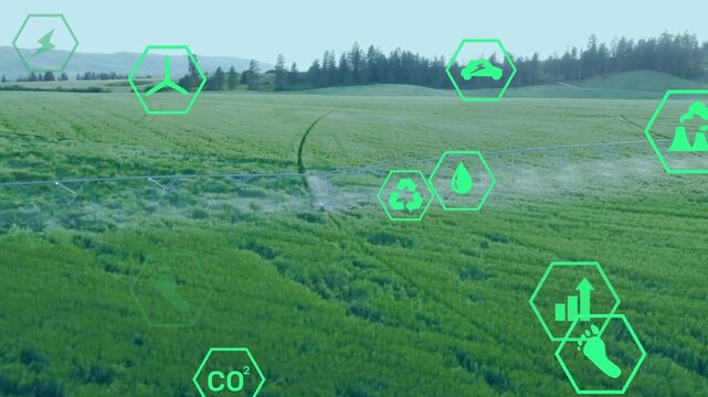 Center pivot moving and spraying mist while green hex icons clustering and showing sustainability
