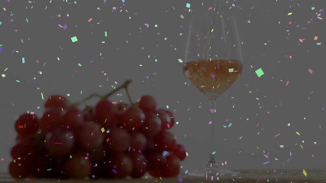 Removal activating tool removing confetti overlay, revealing grapes and wineglass for clean look