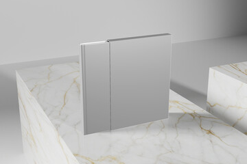 A sleek, silver, rectangular object resembling a hinge or a foldable panel stands upright on a white and gold marble surface © cozzdesign