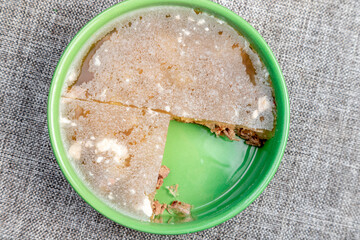 Closeup of authentic traditional Russian holodets (aspic jelly meat) served with mustard and fresh...