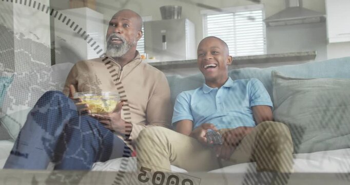 Father holding popcorn, son pressing remote, reacting to show on TV, compass overlaying, laughing