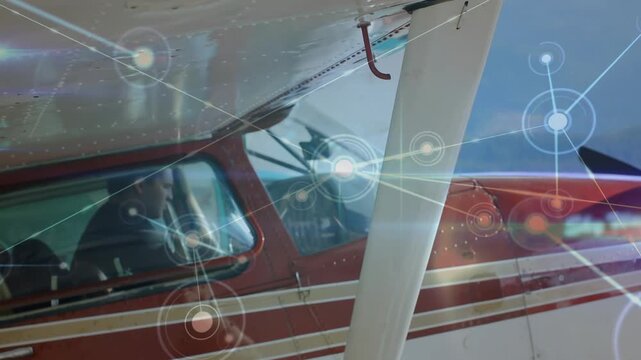 Male pilot running preflight checks and adjusting yoke as node graphics expanding across windshield