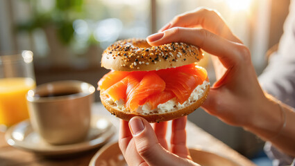 Bagel with smoked salmon and cream cheese held by hands, breakfast setup, morning meal inspiration, culinary blog or magazine feature, cafe menu special offer