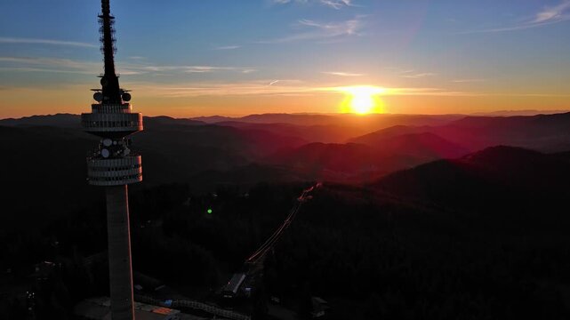 Tower Snezhana on peak of Snezhana covered with spruce forests in Rhodope mountains