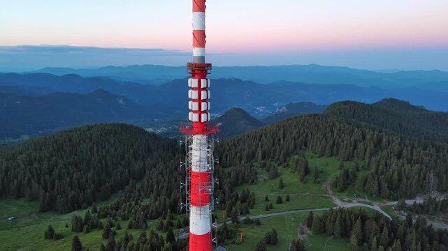 Tower Snezhana on peak of Snezhana covered with spruce forests in Rhodope mountains