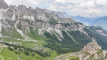 Aerial, bird view, vie winto valley near Rotwandh&uuml;tte, Rifugio Roda di Va&egrave;l mountain hut in Italian Dolomites. Wonderful hiking destination. Some hikers, tourists standing on the rocky top. Outdoor tr