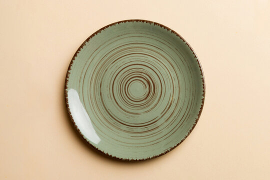 Top view of isolated of colored background empty round green plate for food. Empty dish with space for your design