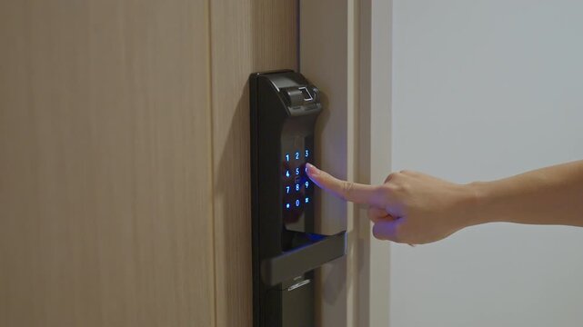 Hand press PIN number for smart digital door lock while open or close the door at home or apartment. NFC Technology, Fingerprint scan, keycard, smartphone and contactless lifestyle concepts